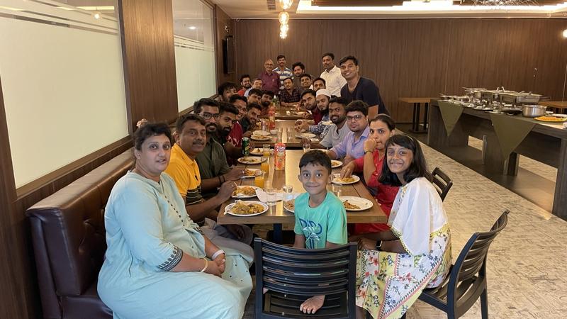 The group sharing a meal at a long table